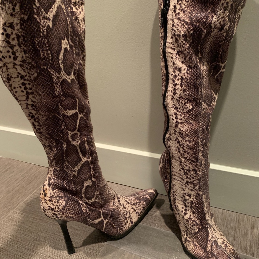 Snake skin high heel boots.